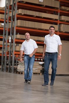 Portrait of independent designers in their furniture manufacturing workshop, looking relaxed and confident