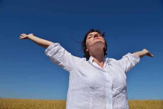 healthy Happy  young woman with spreading arms, blue sky with clouds in background  - copyspace