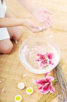 hand  and nail spa and beauty treatment with aroma and flowers in water isolated on white