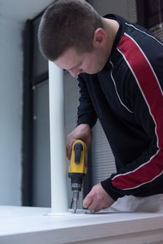 repairman working with drilling machine and assambling  furniture