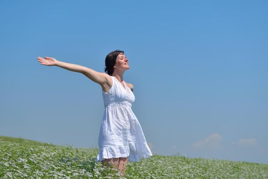 healthy Happy  young woman with spreading arms, blue sky with clouds in background  - copyspace