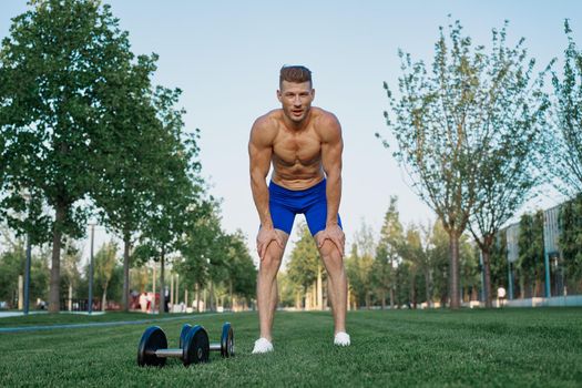 sporty man in park exercise crossfit workout. High quality photo