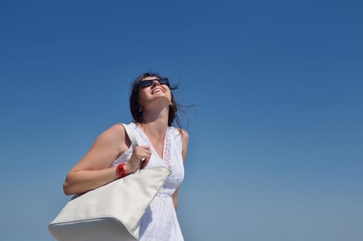 happy young tourist woman have fun while traveling araund city with blue sky and sea in background