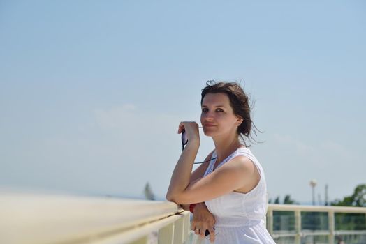 happy young tourist woman have fun while traveling araund city with blue sky and sea in background