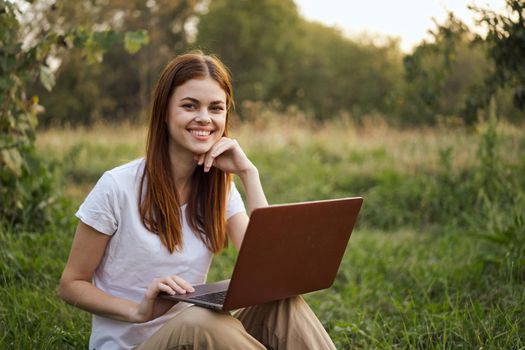 cheerful woman outdoors laptops communication internet. High quality photo