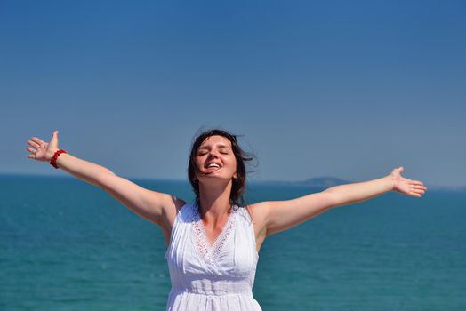 healthy Happy  young woman with spreading arms, blue sky with clouds in background  - copyspace