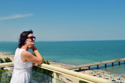 happy young tourist woman have fun while traveling araund city with blue sky and sea in background