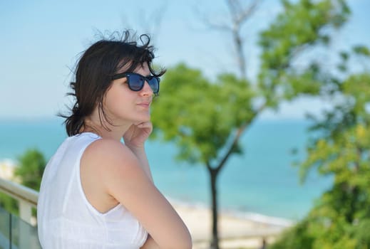 happy young tourist woman have fun while traveling araund city with blue sky and sea in background