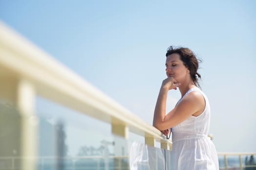 happy young tourist woman have fun while traveling araund city with blue sky and sea in background