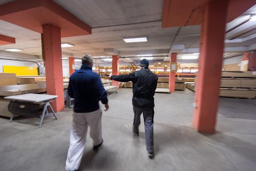 two young carpenters working together in big modern carpentry High quality wood concept