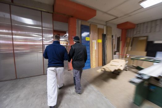 two young carpenters working together in big modern carpentry High quality wood concept