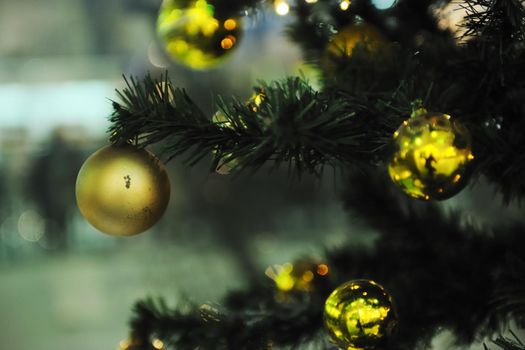 xmas tree decoration closeup with blured lights in shopping centre in backgroun