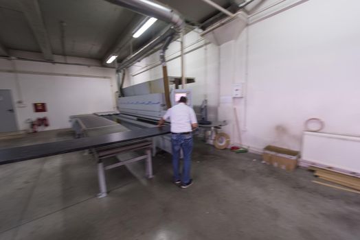 two worker working in a factory for the production of wooden furniture