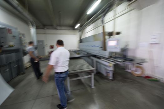 two worker working in a factory for the production of wooden furniture