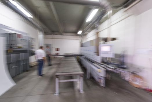 two worker working in a factory for the production of wooden furniture