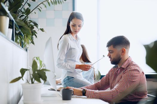 Young business people working together on project in modern office close up