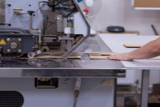 young positive engineer in front of furniture manufacture production at wood cutting machine