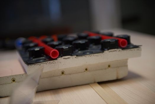 Black underfloor heating posed in a under construction building