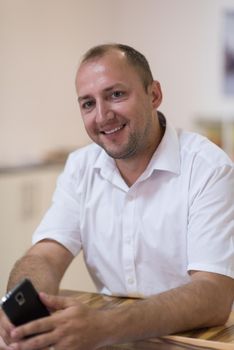 Portrait of an independent designer in his furniture manufacturing workshop, looking relaxed and confident