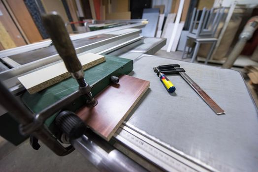 clamp and ruler tools on desk in factory for the production of wooden furniture