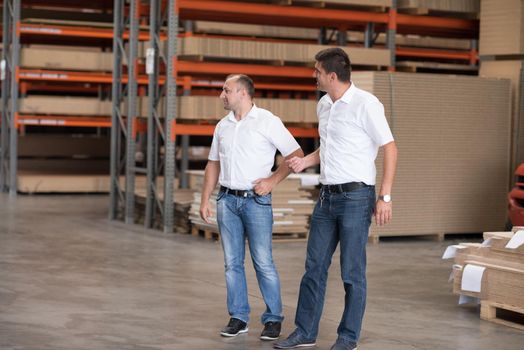 Portrait of independent designers in their furniture manufacturing workshop, looking relaxed and confident