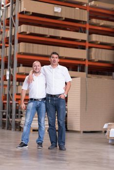 Portrait of independent designers in their furniture manufacturing workshop, looking relaxed and confident