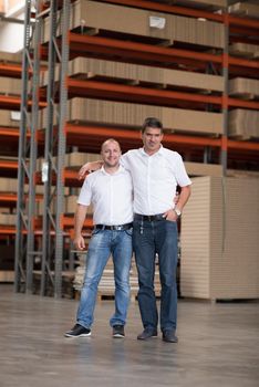 Portrait of independent designers in their furniture manufacturing workshop, looking relaxed and confident