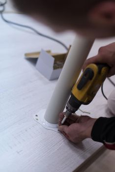 repairman working with drilling machine and assambling  furniture