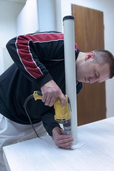 repairman working with drilling machine and assambling  furniture