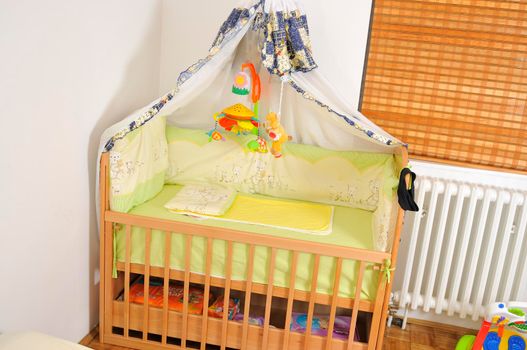 baby bed with colorful toys indoor