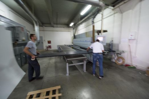 two worker working in a factory for the production of wooden furniture