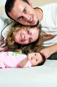 indoor portrait with happy young famil and  cute little babby 