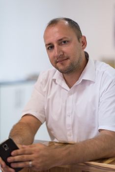 Portrait of an independent designer in his furniture manufacturing workshop, looking relaxed and confident