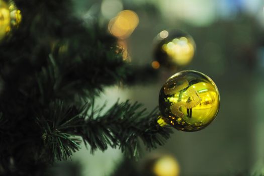 xmas tree decoration closeup with blured lights in shopping centre in backgroun