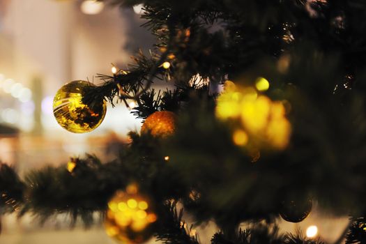 xmas tree decoration closeup with blured lights in shopping centre in backgroun