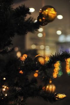 xmas tree decoration closeup with blured lights in shopping centre in backgroun