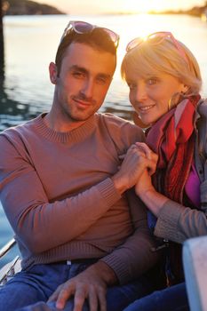 happy young couple in love  have romantic time at summer sunset   at ship boat while  representing urban and countryside fashin lifestyle