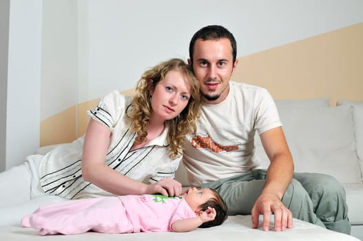 indoor portrait with happy young famil and  cute little babby 