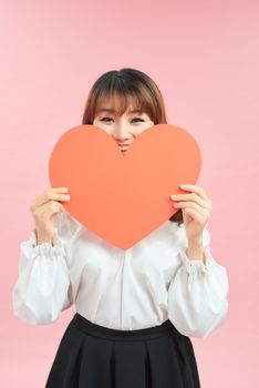 Woman holding paper heart shaped card