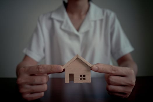 Real estate agent woman or bank officer showing house model. The concept for real estate and home Investment property.