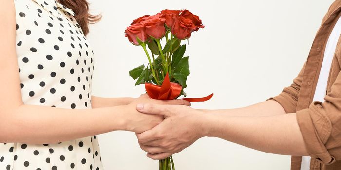 man giving rose flowers to girl