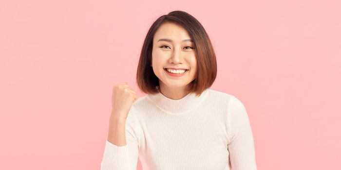 Attractive beautiful Asian woman hands up raised arms from happiness, Excited businesswoman winner success concept