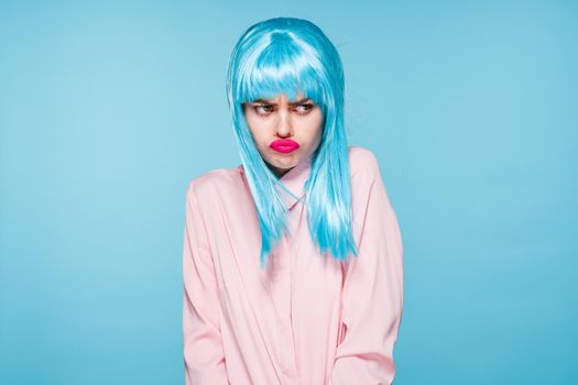 cheerful glamorous woman in pink shirt blue wig makeup model. High quality photo