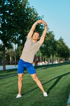 athletic man in the park workout jogging exercise summer. High quality photo