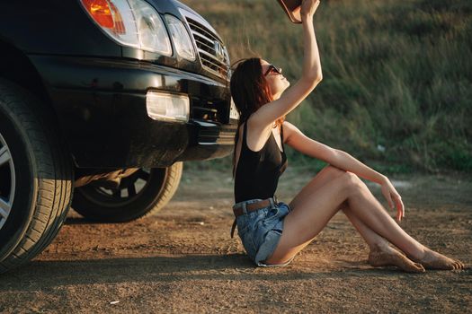 woman in sunglasses near car travel summer vacation landscape. High quality photo