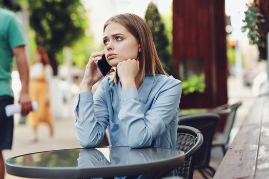 Business woman in a cafe in the summer outdoors on vacation. High quality photo