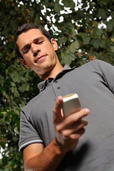 young happy  casual man talking on cellphone and writing sms message