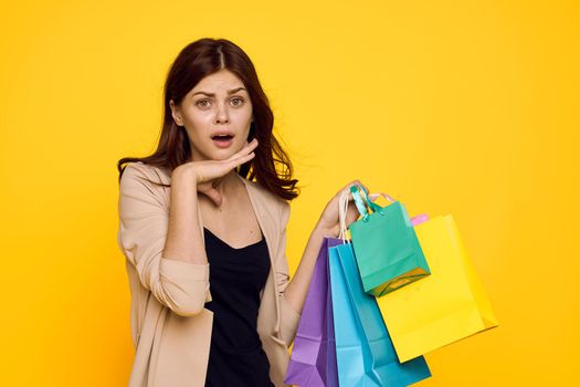smiling woman with multicolored bags posing isolated background. High quality photo