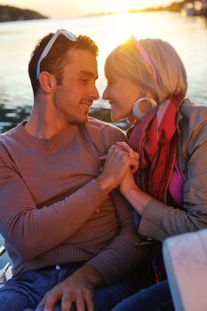 happy young couple in love  have romantic time at summer sunset   at ship boat while  representing urban and countryside fashin lifestyle