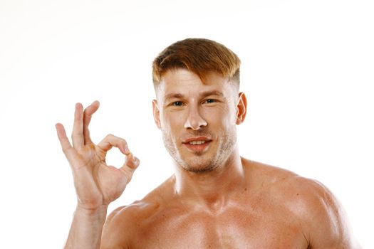 athletic man pumped up press gestures with hands posing fitness. High quality photo